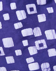 Close up display of long sleeve purple blouse with small with squares.