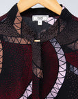 Display of red, beige, white and black geometric print dress.