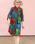 Model wearing rainbow pixelated print dress. 