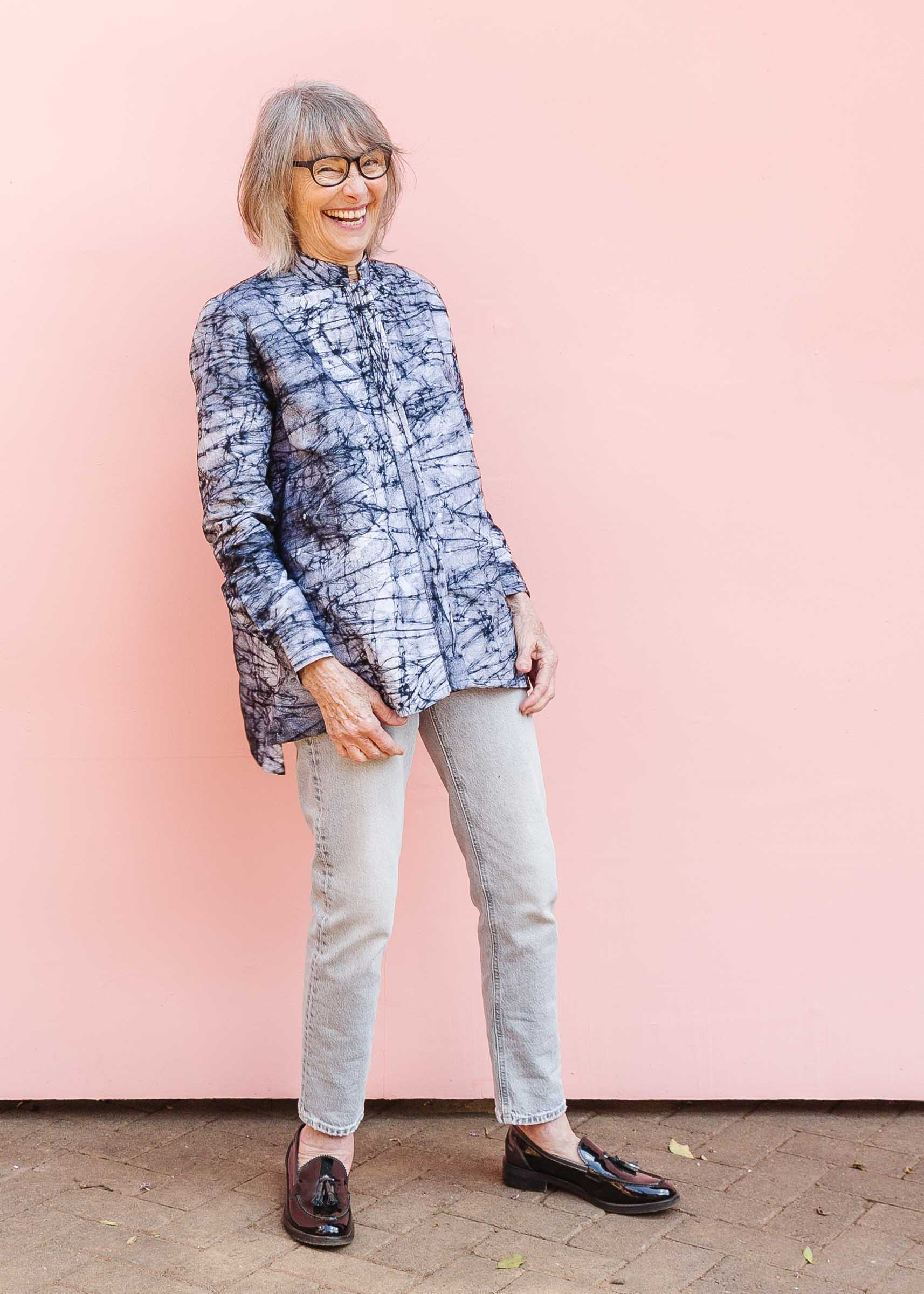 Model wearing black and white long sleeve batik blouse.