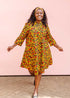 The model is wearing black dress with yellow and red small blob print.