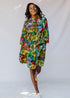 model wearing a multicolor leaf design dress
