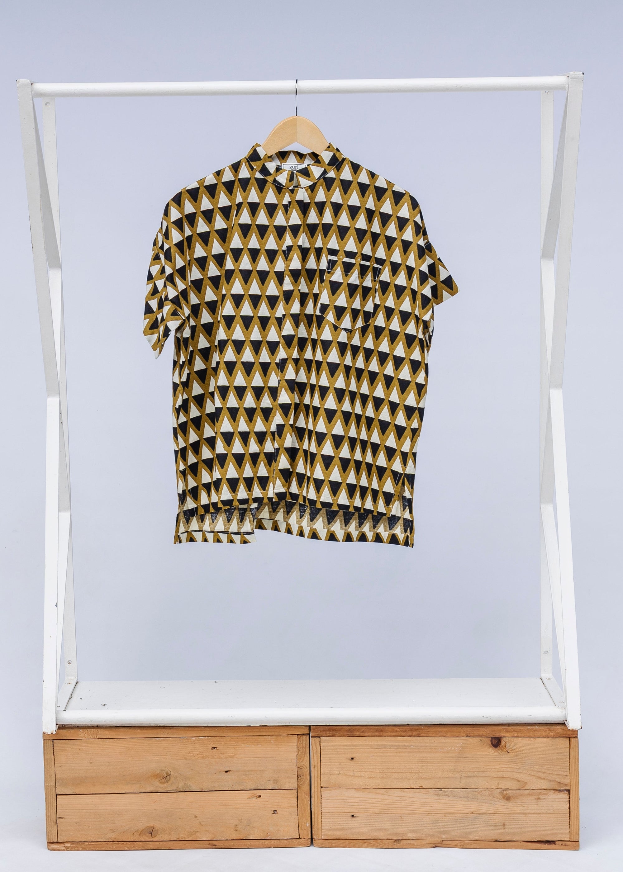 Display of black and white triangle print shirt.