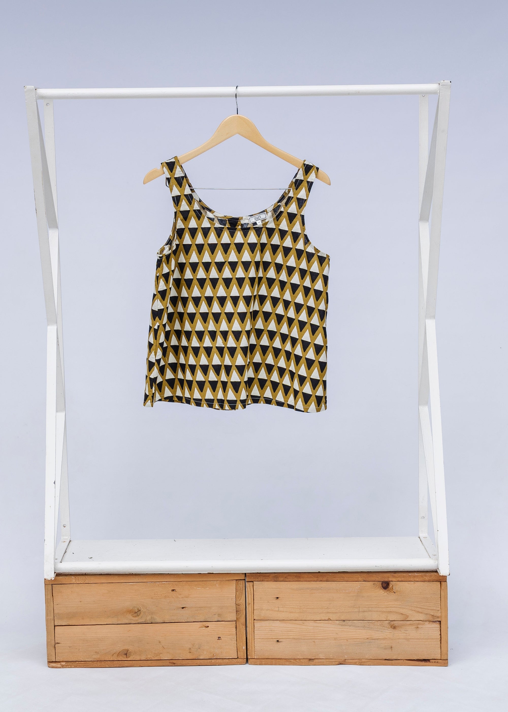 Display of mustard and black triangle print tank.