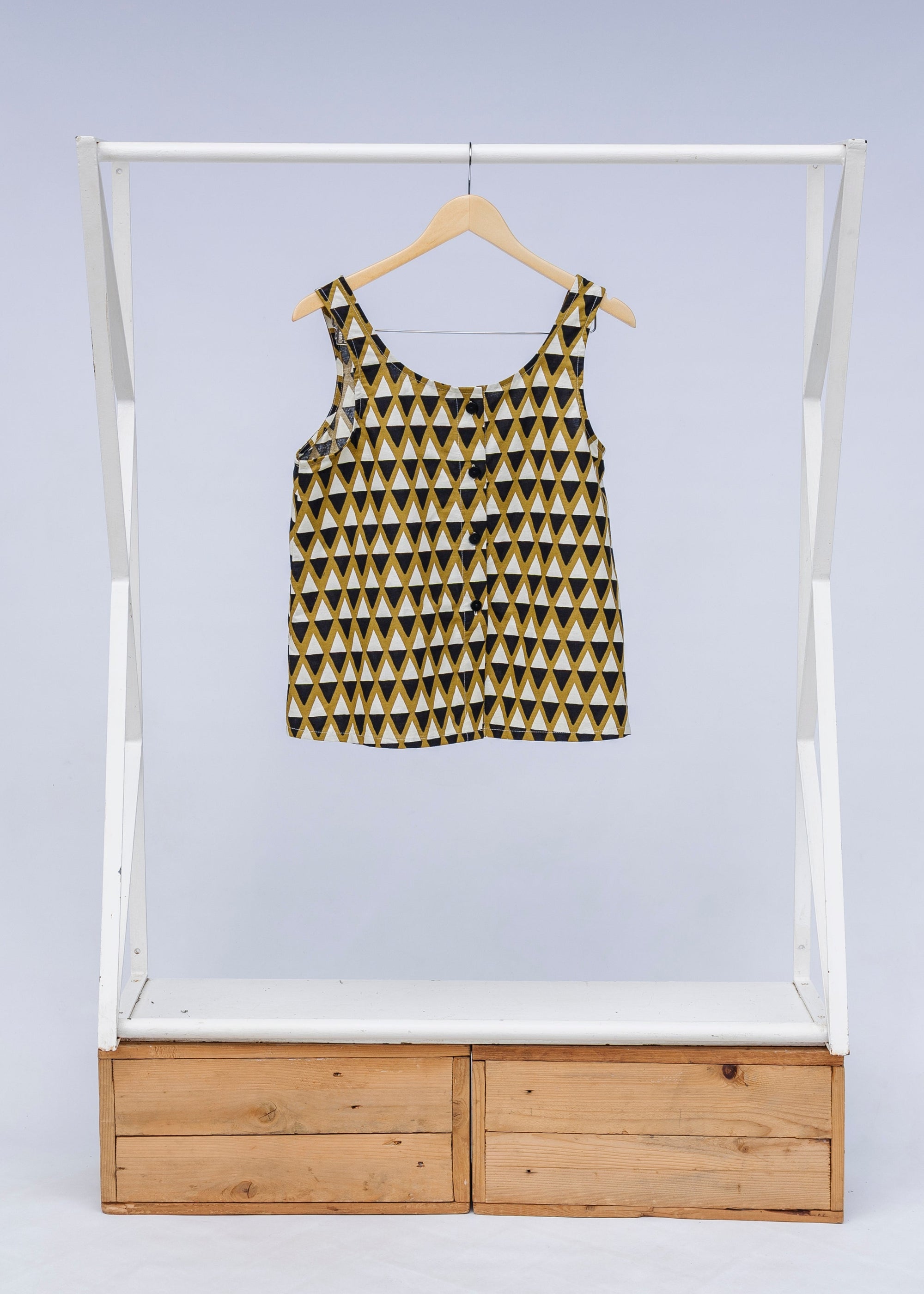 Display of mustard and black triangle print tank.