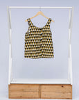 Display of mustard and black triangle print tank.