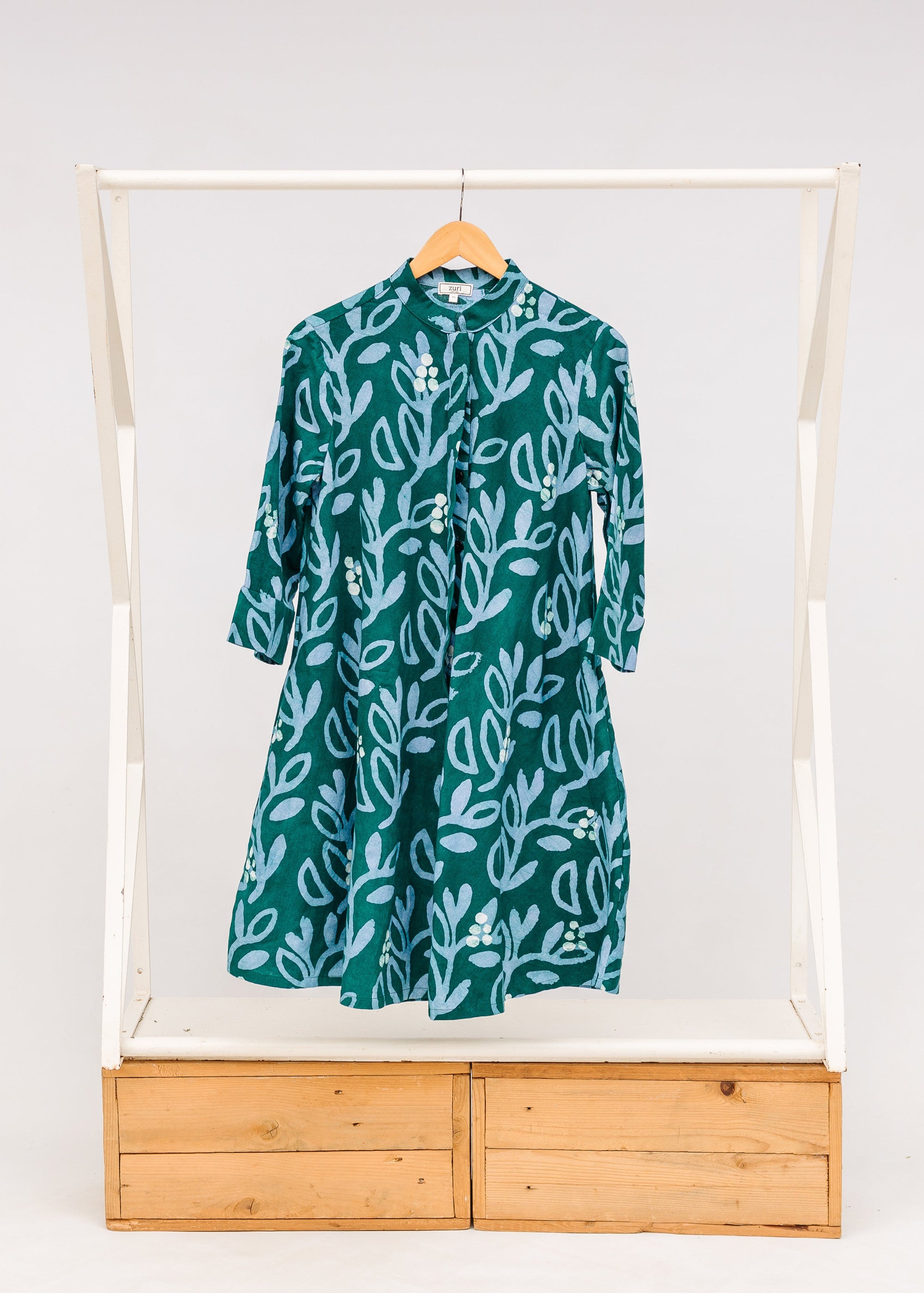 Display of green and blue floral batik dress. 