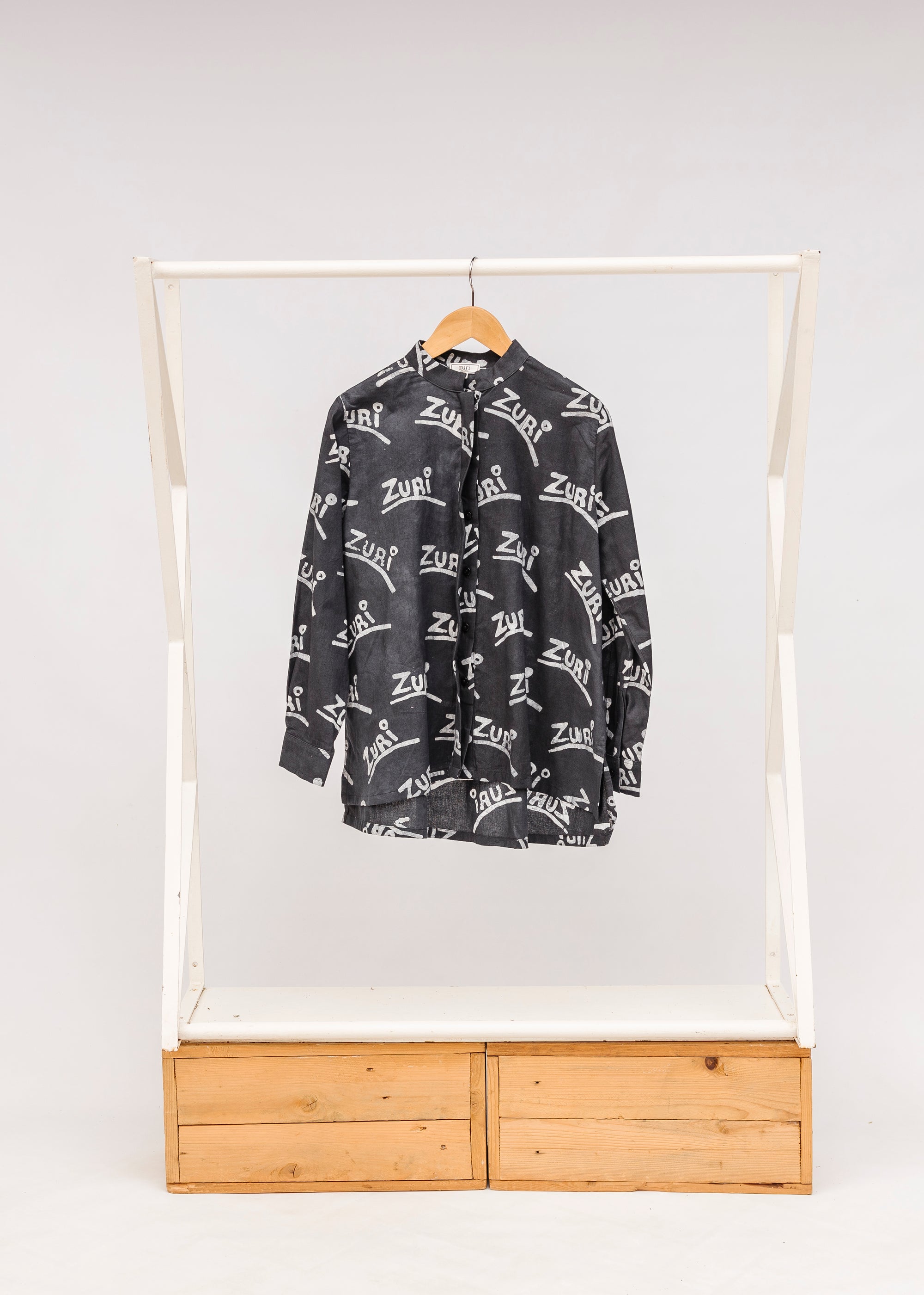 Display of black and white long sleeve shirt with Zuri graphic print.