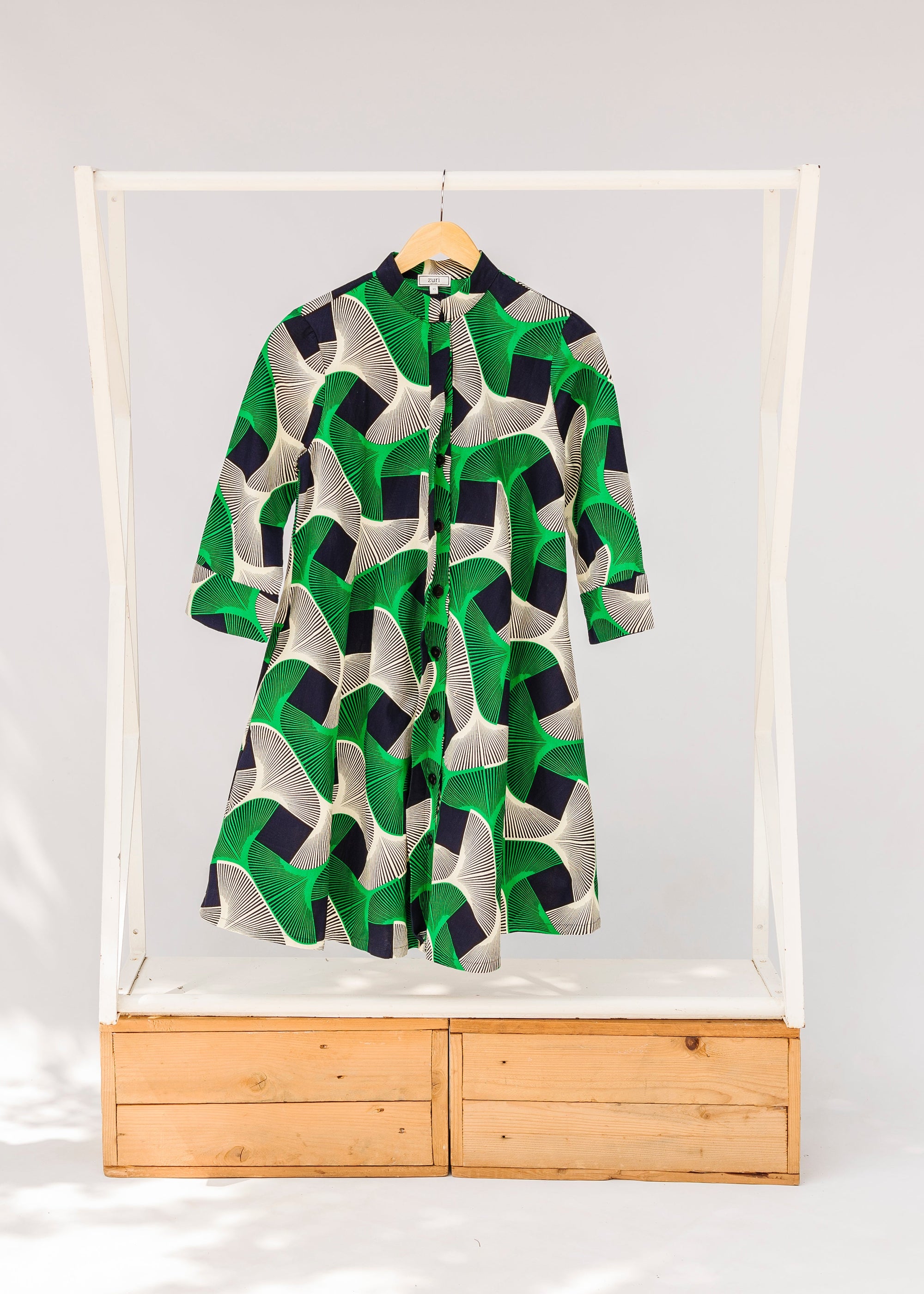 Display of green, black and white abstract print dress. 