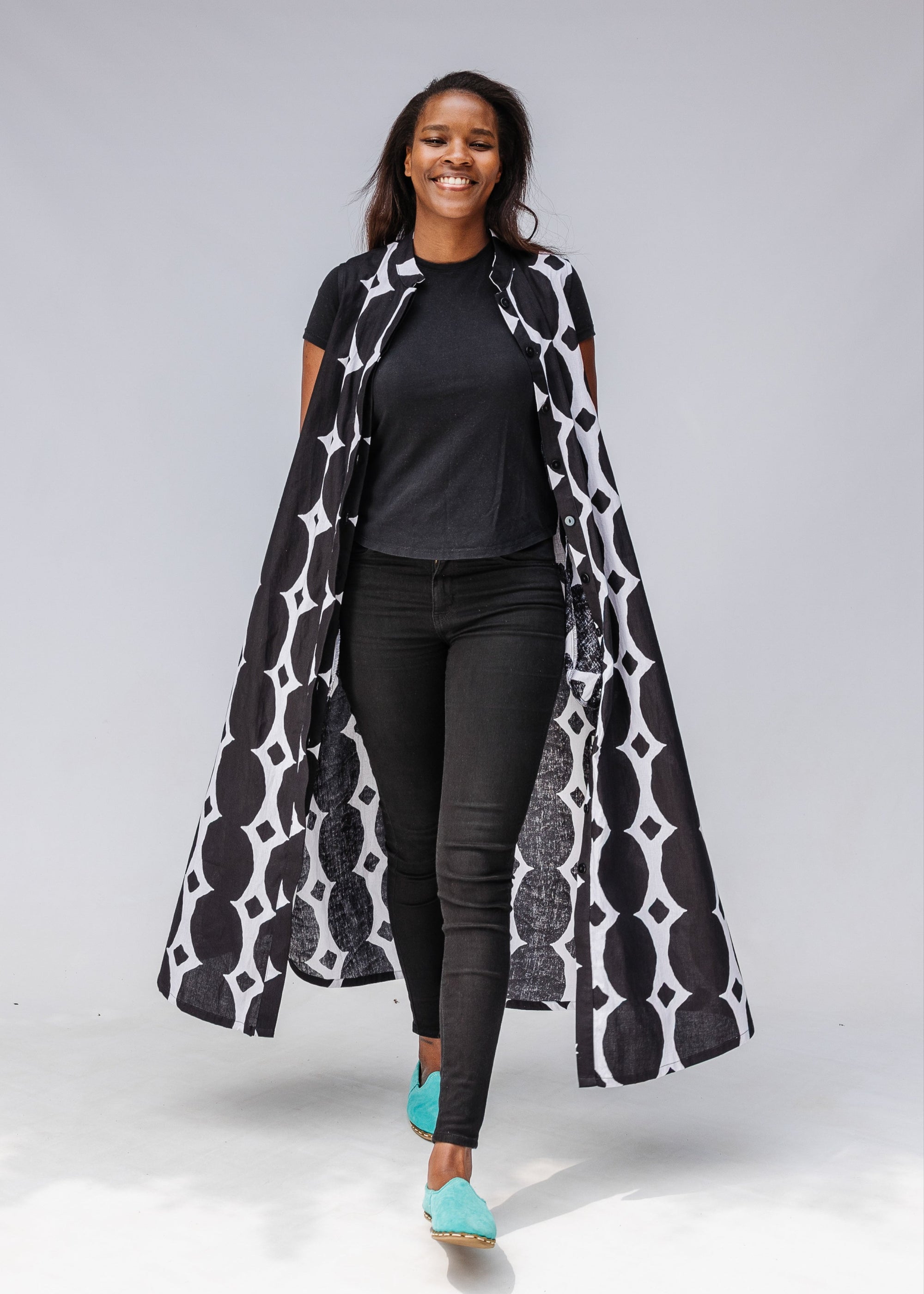 Model wearing black and white geometric print dress.