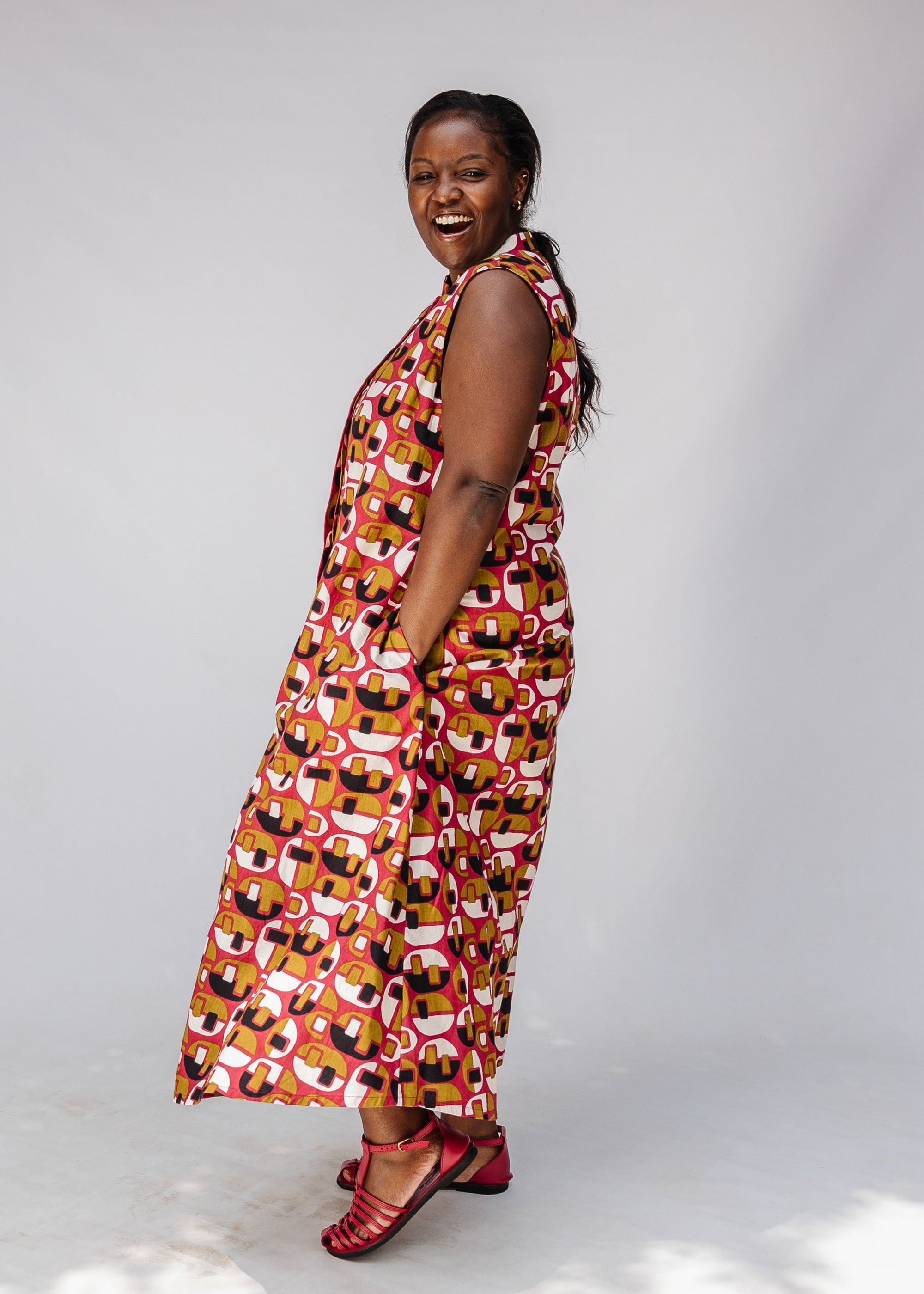 Model wearing geometric print dress.