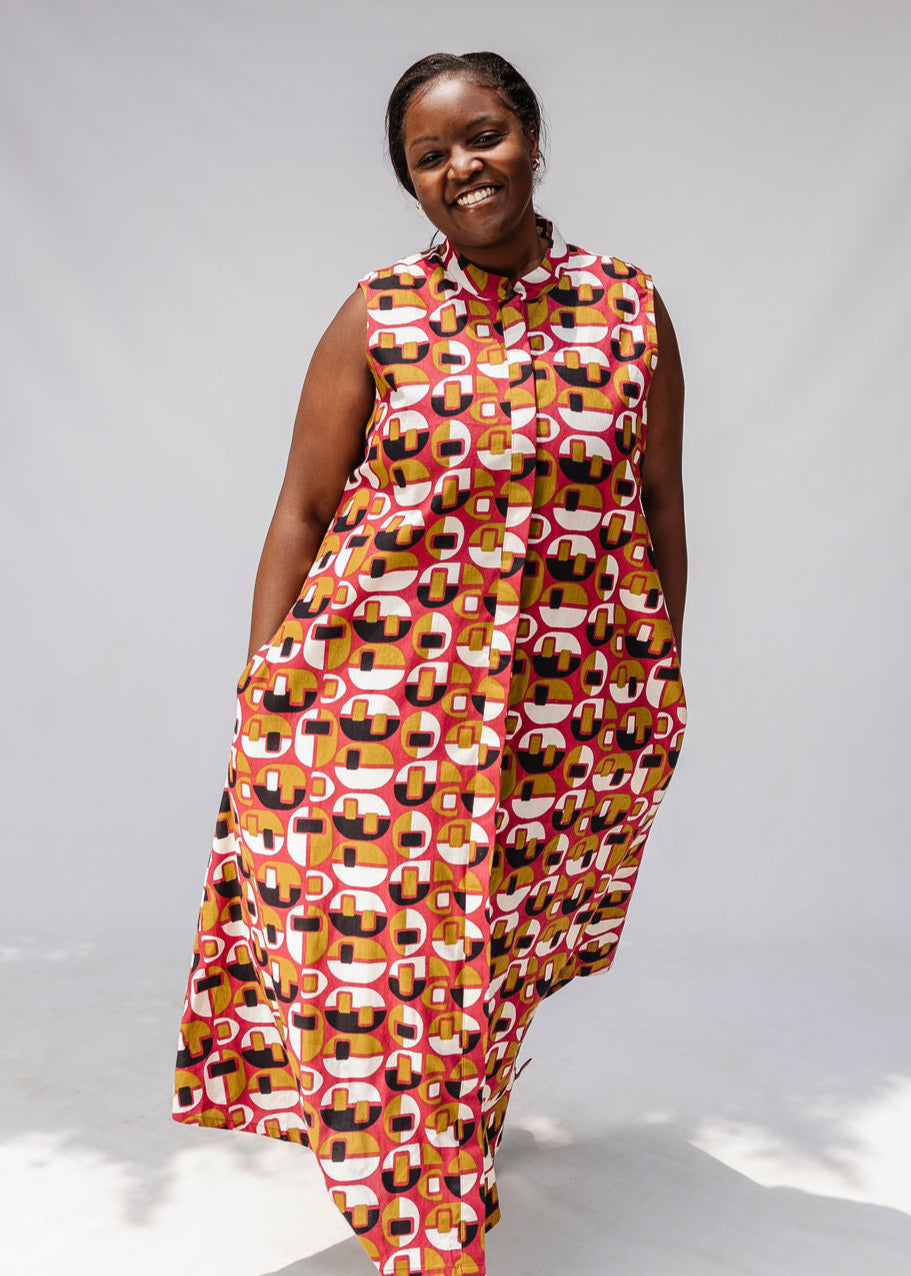 Model wearing geometric print dress.