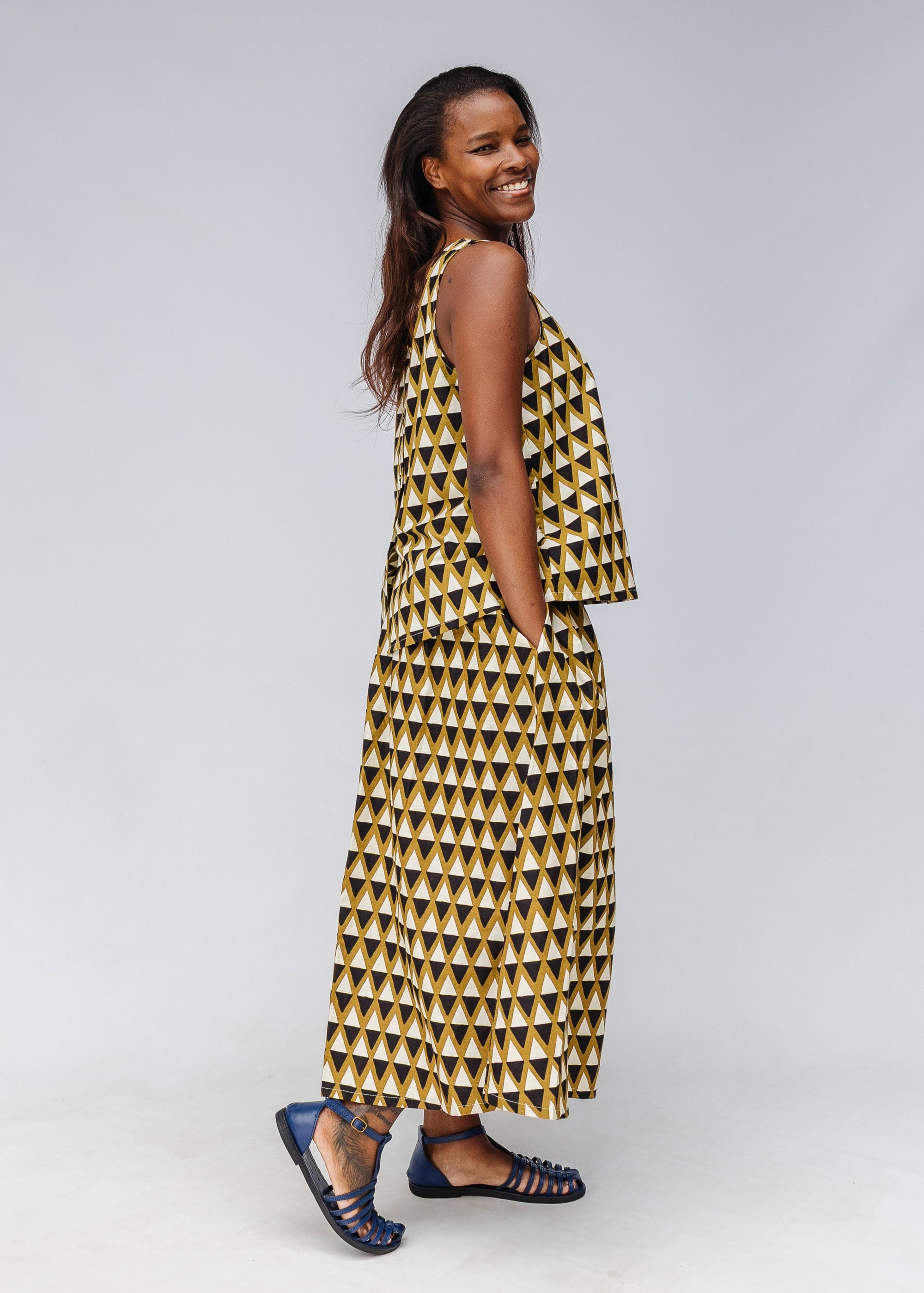 Model wearing black and white triangle print shirt and pants.