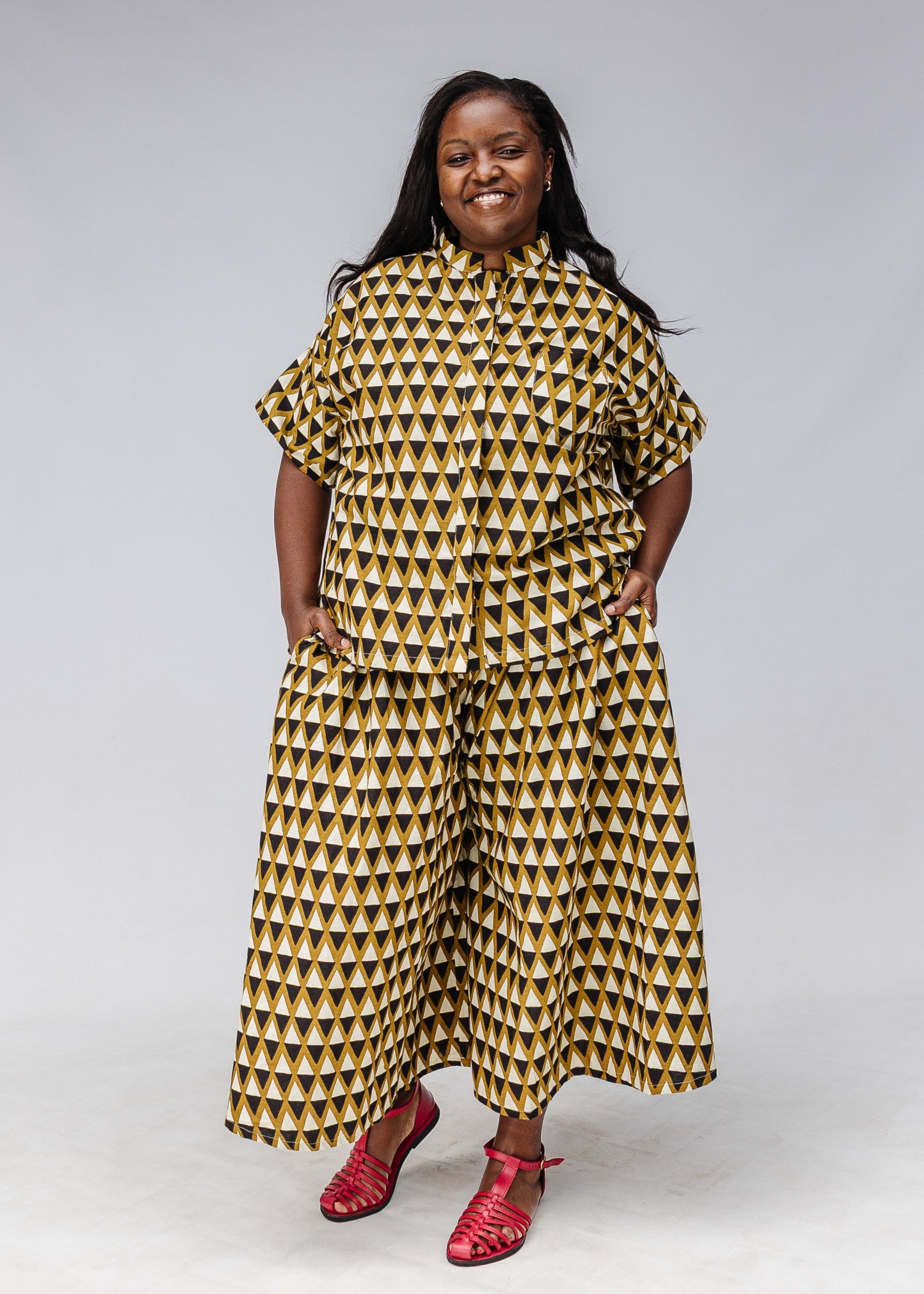 Model wearing black and white triangle print shirt and pants.