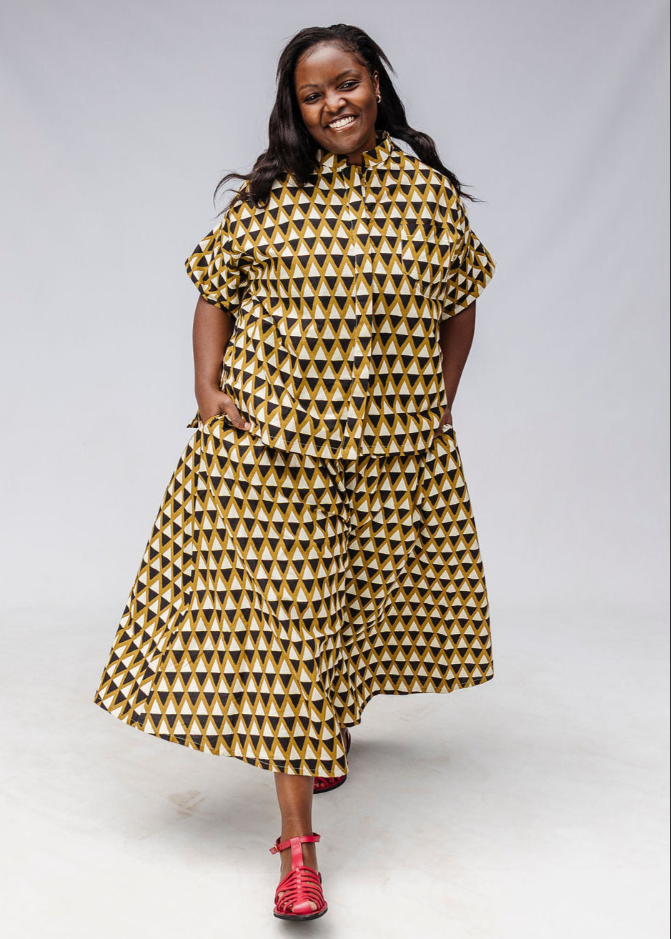 Model wearing black and white triangle print shirt and pants.