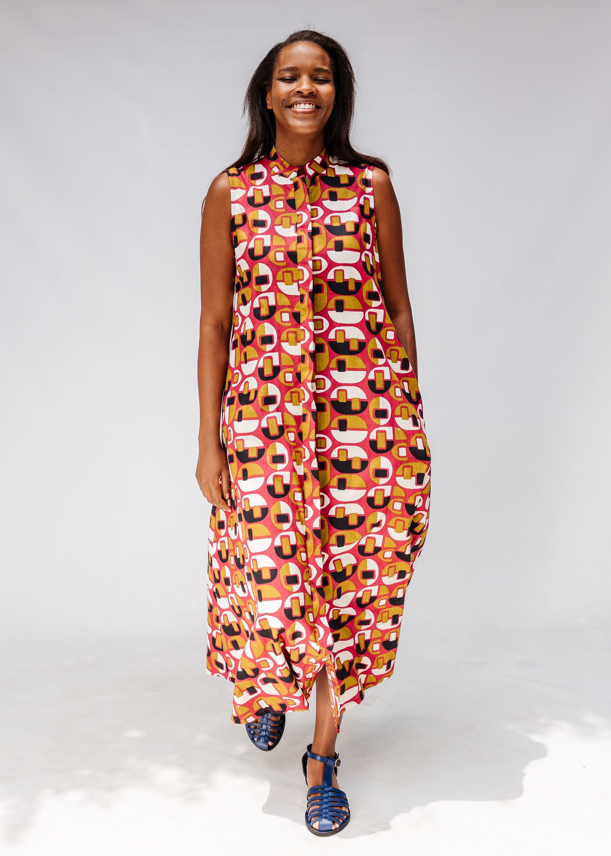 Model wearing geometric print dress.