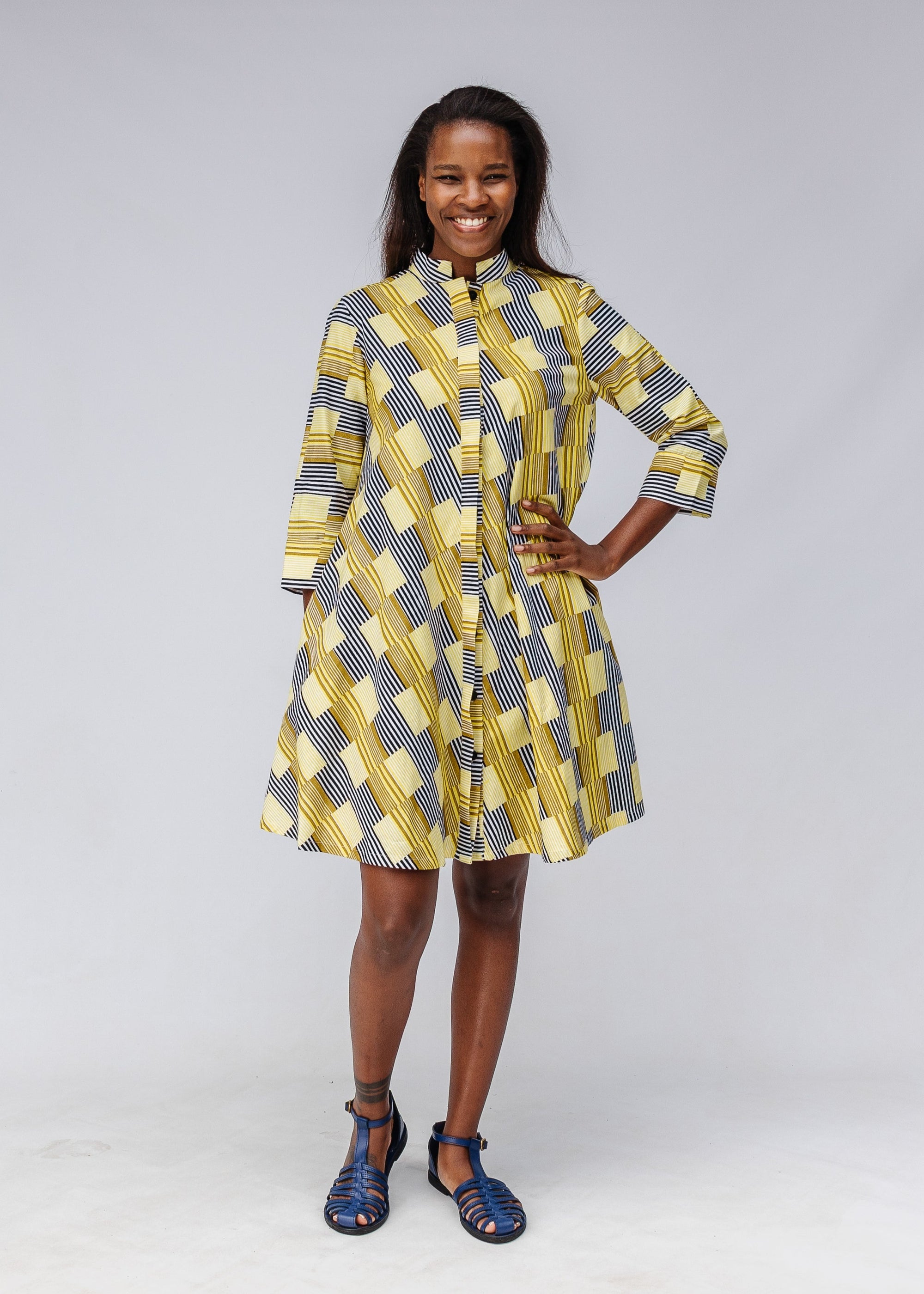 Model wearing yellow and black striped dress.