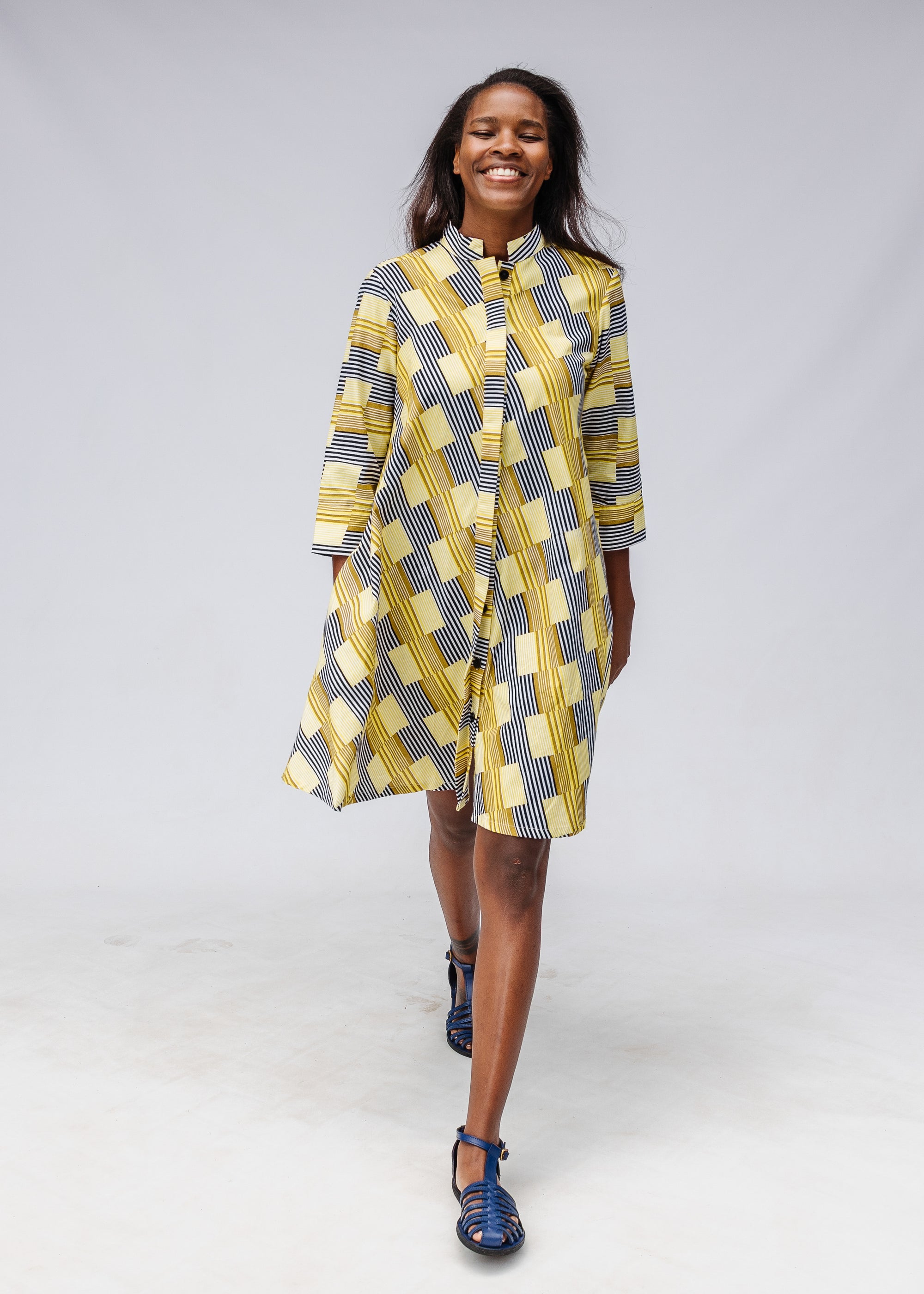 Model wearing yellow and black striped dress.