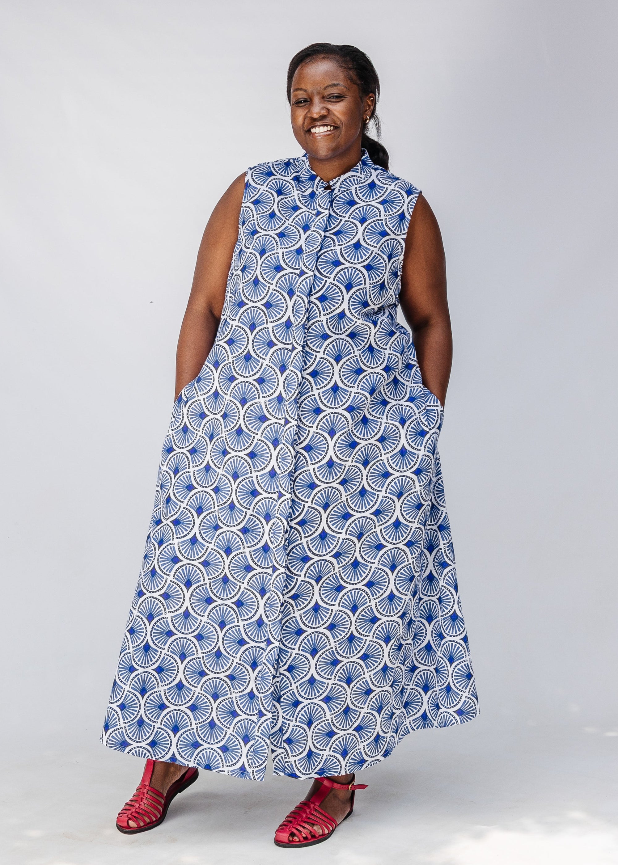 Model wearing blue and white mosaic print dress.