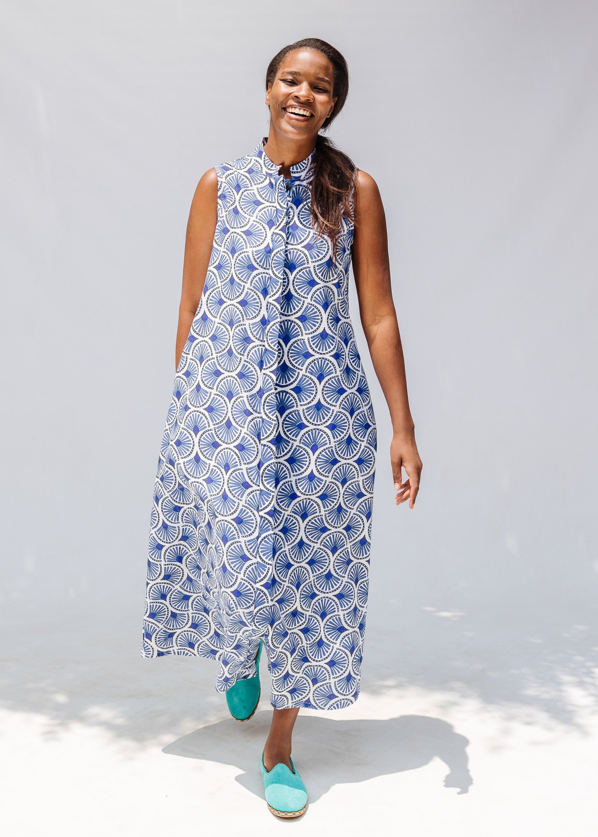 Model wearing blue and white mosaic print dress.