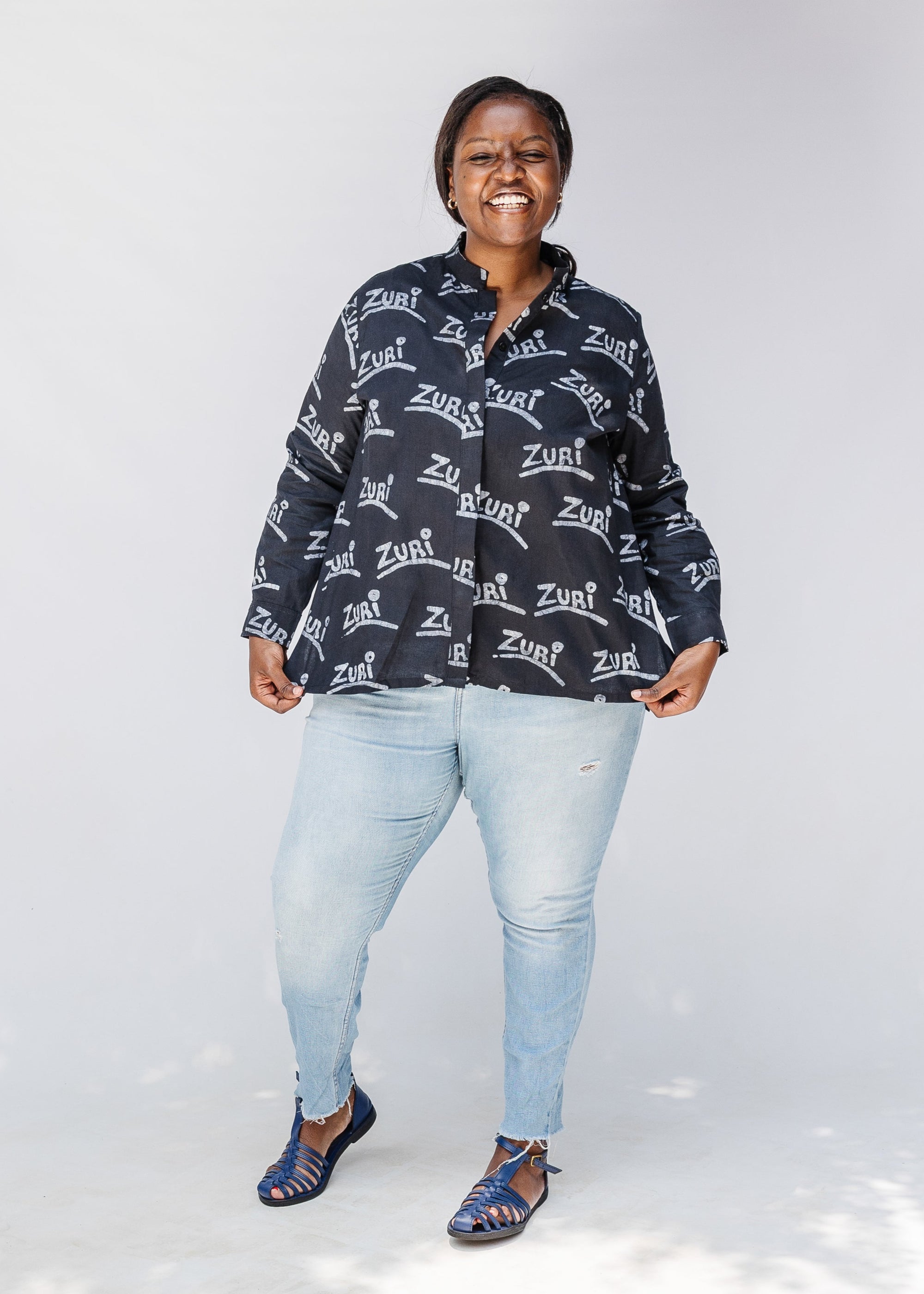 Model wearing black and white long sleeve shirt with Zuri graphic print.