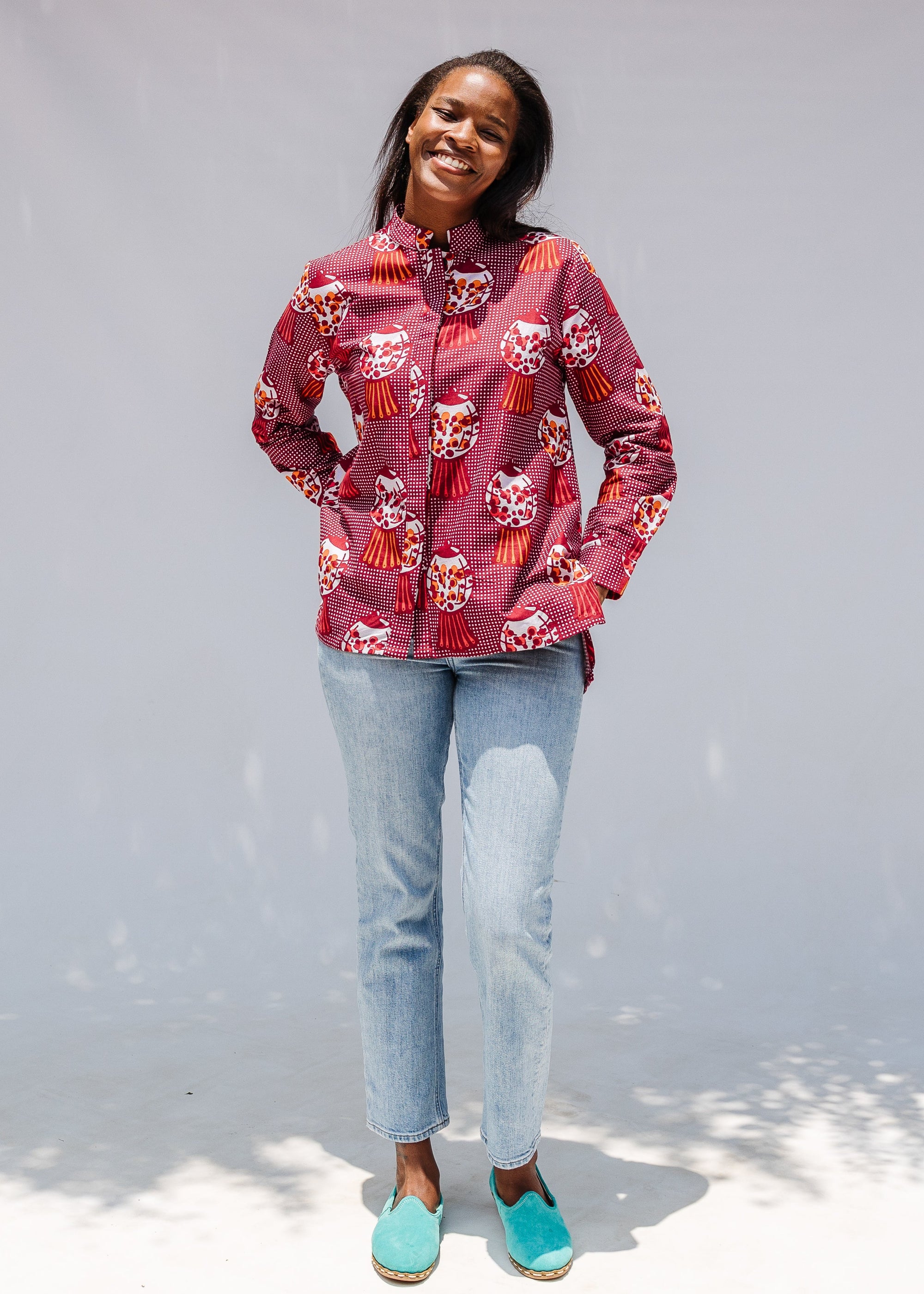 Model wearing red shirt with orange and white gumball print.