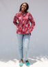 Model wearing red shirt with orange and white gumball print.