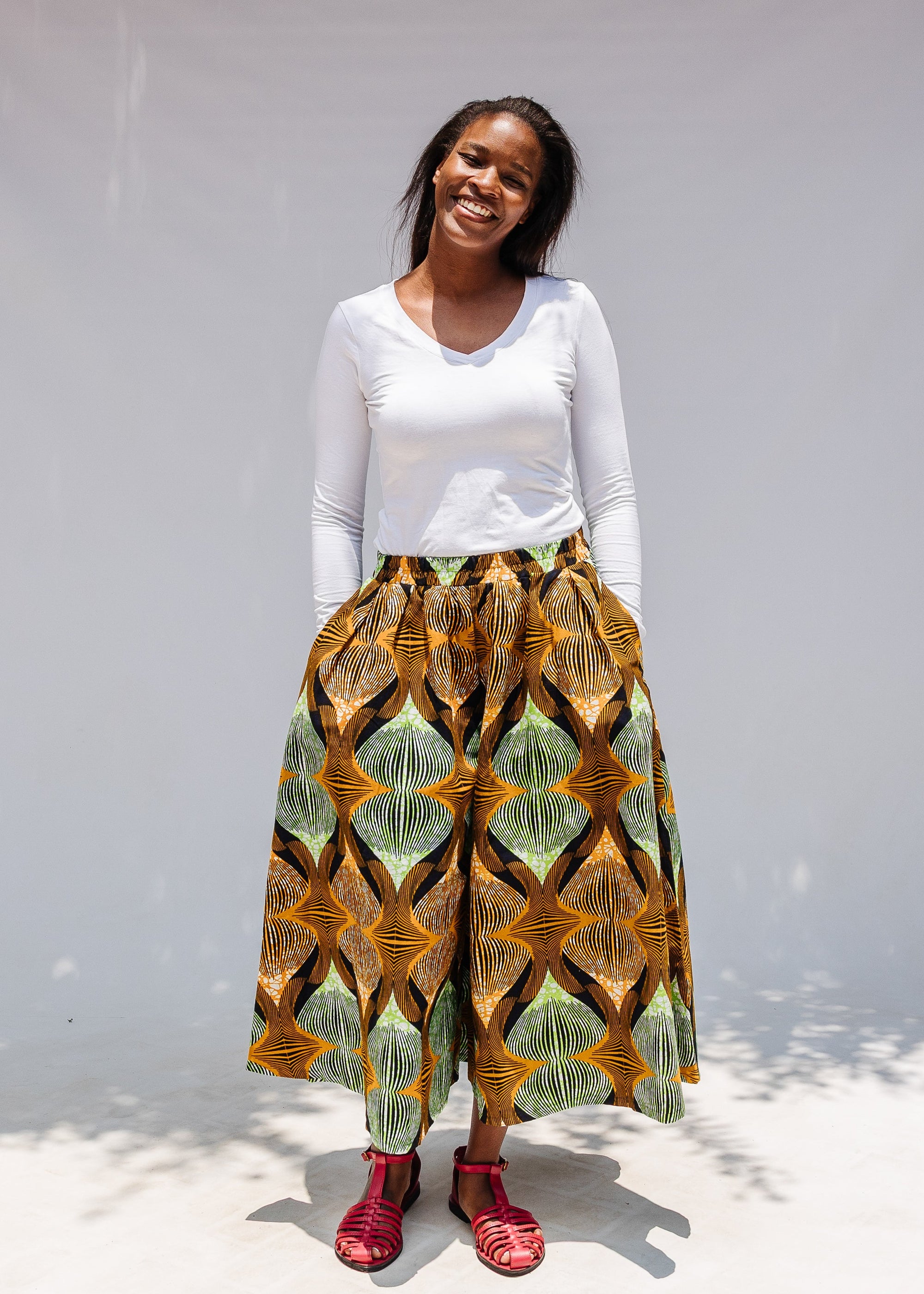 Model wearing orange and green geometric print pants.