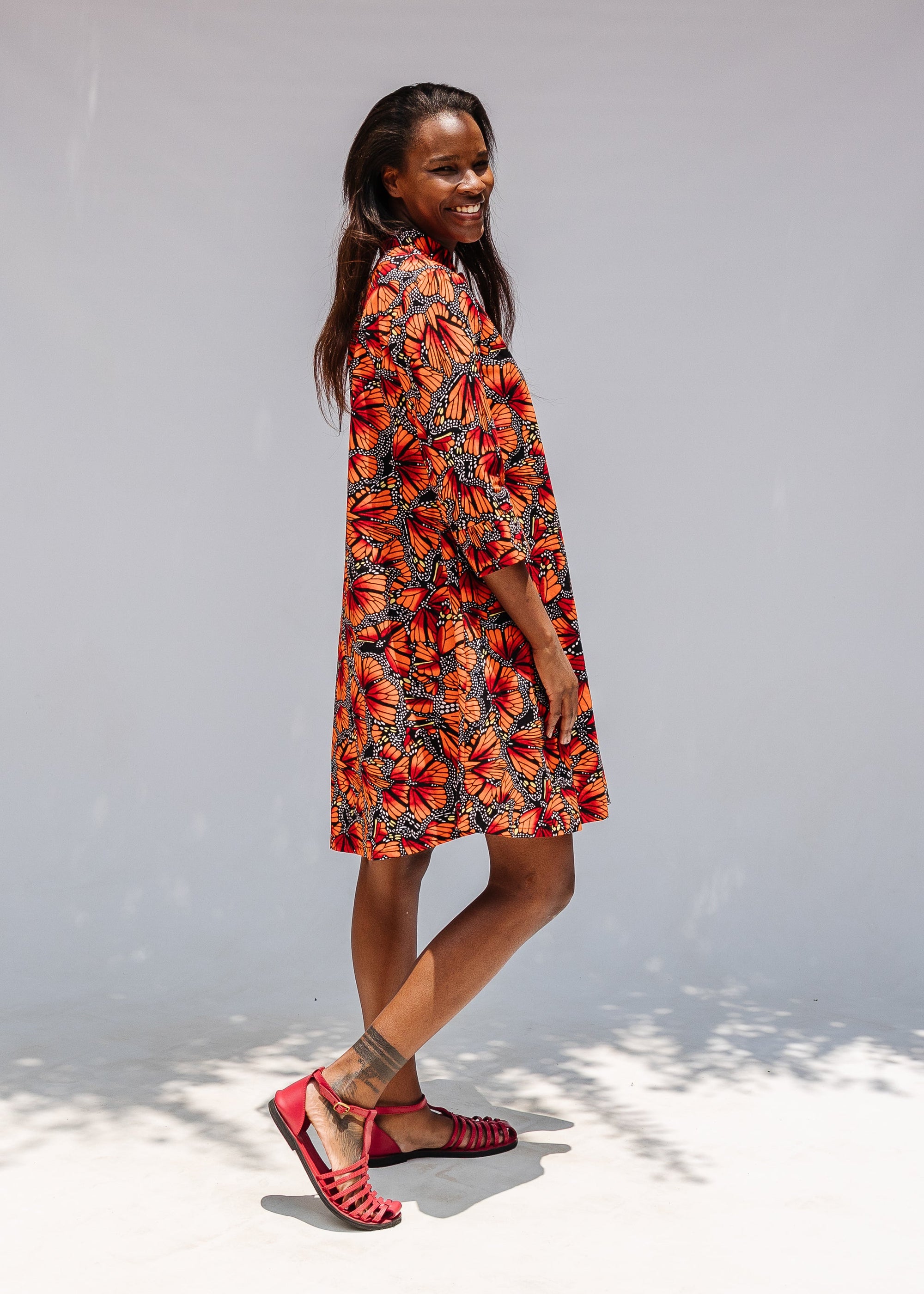 Model wearing butterfly print dress.