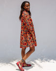 Model wearing butterfly print dress.