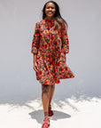 Model wearing butterfly print dress.