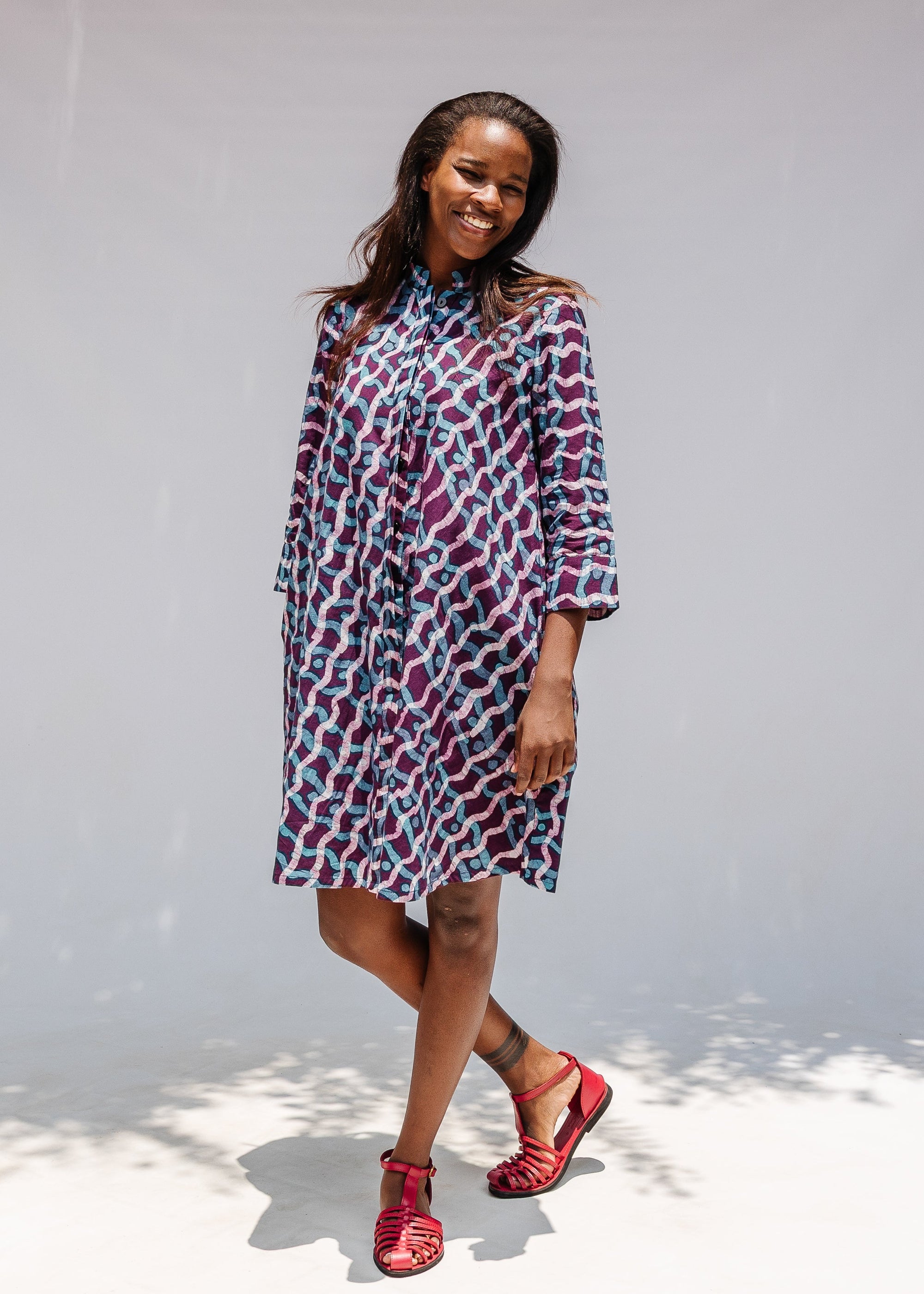 Model wearing purple and blue batik dress.