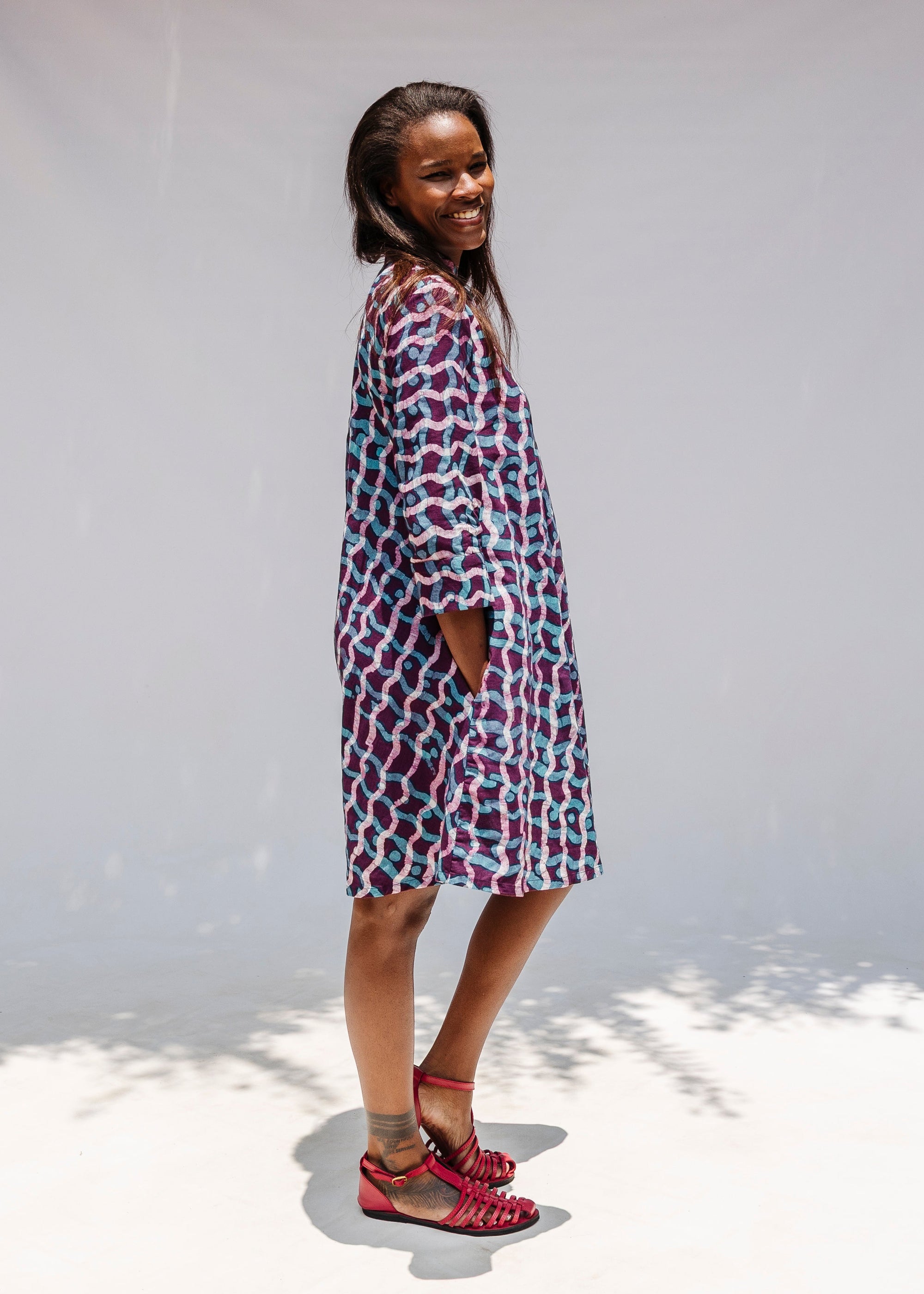 Model wearing purple and blue batik dress.
