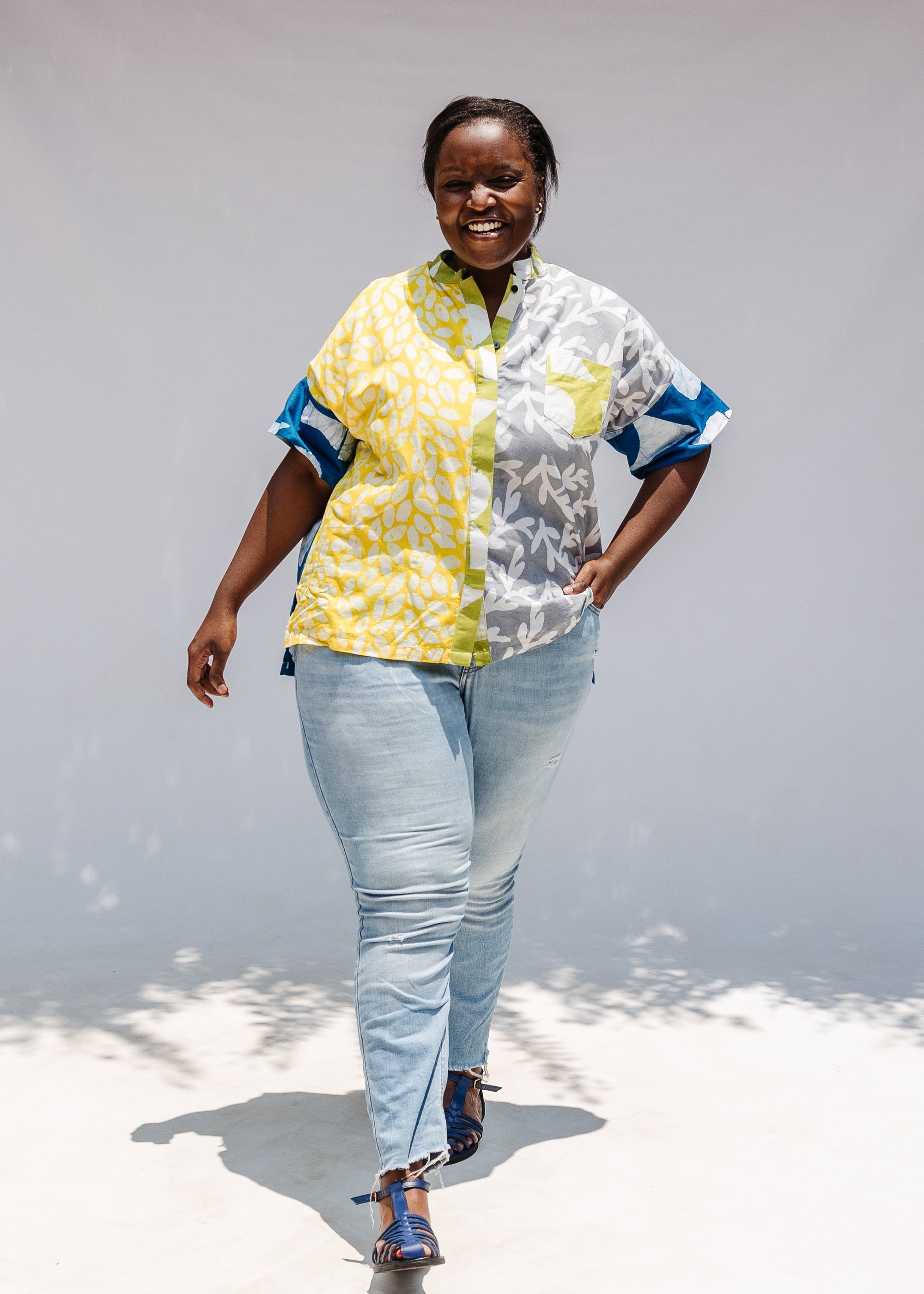 Model wearing mutlicolored batik shortsleeved shirt.