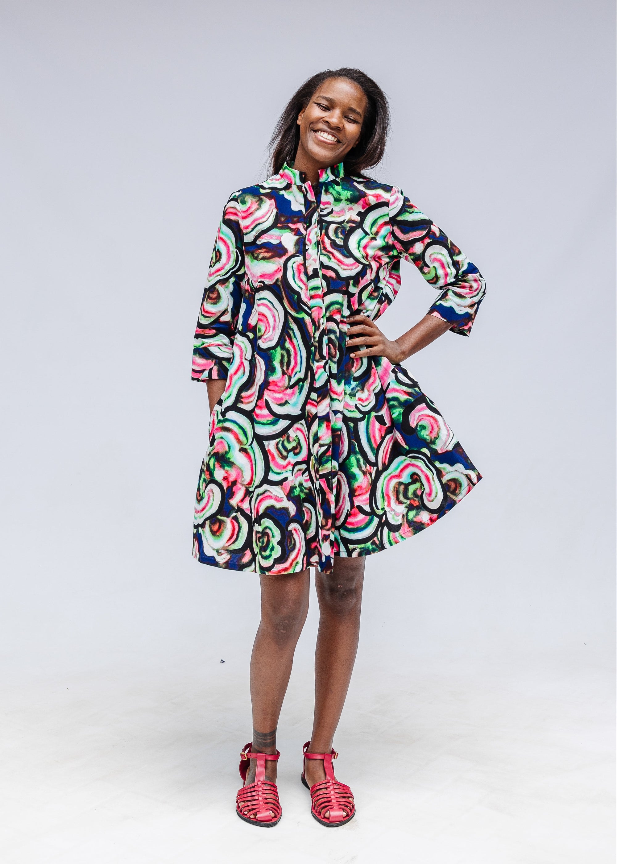 Model wearing colorful abstract print dress.
