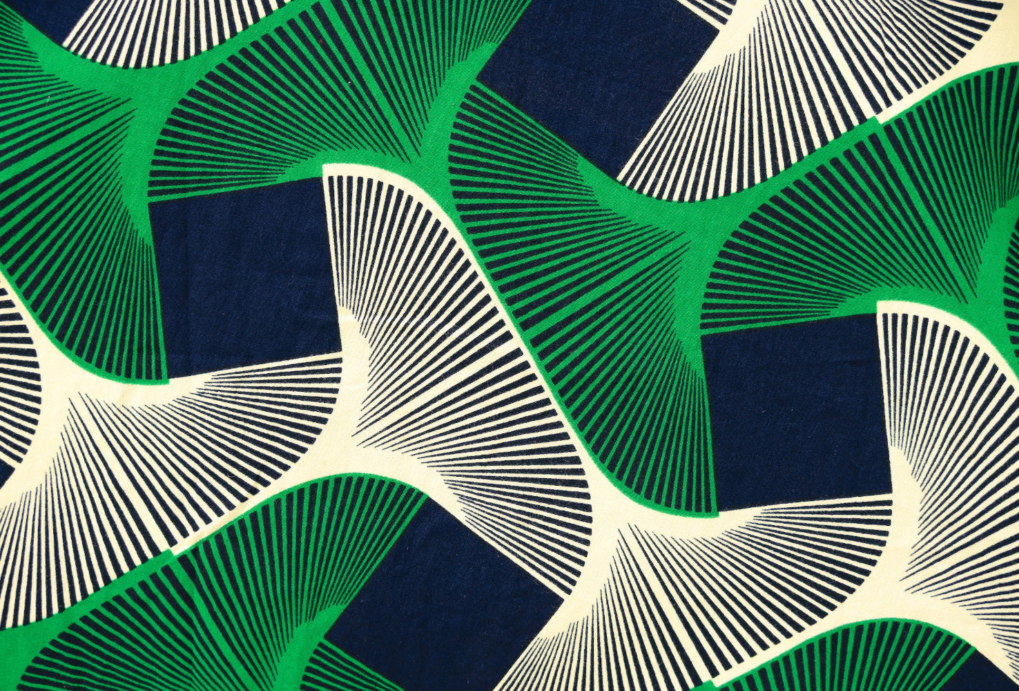 Close up display of green, black and white abstract print dress. 