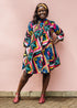 The model is wearing multi colored geometric print dress