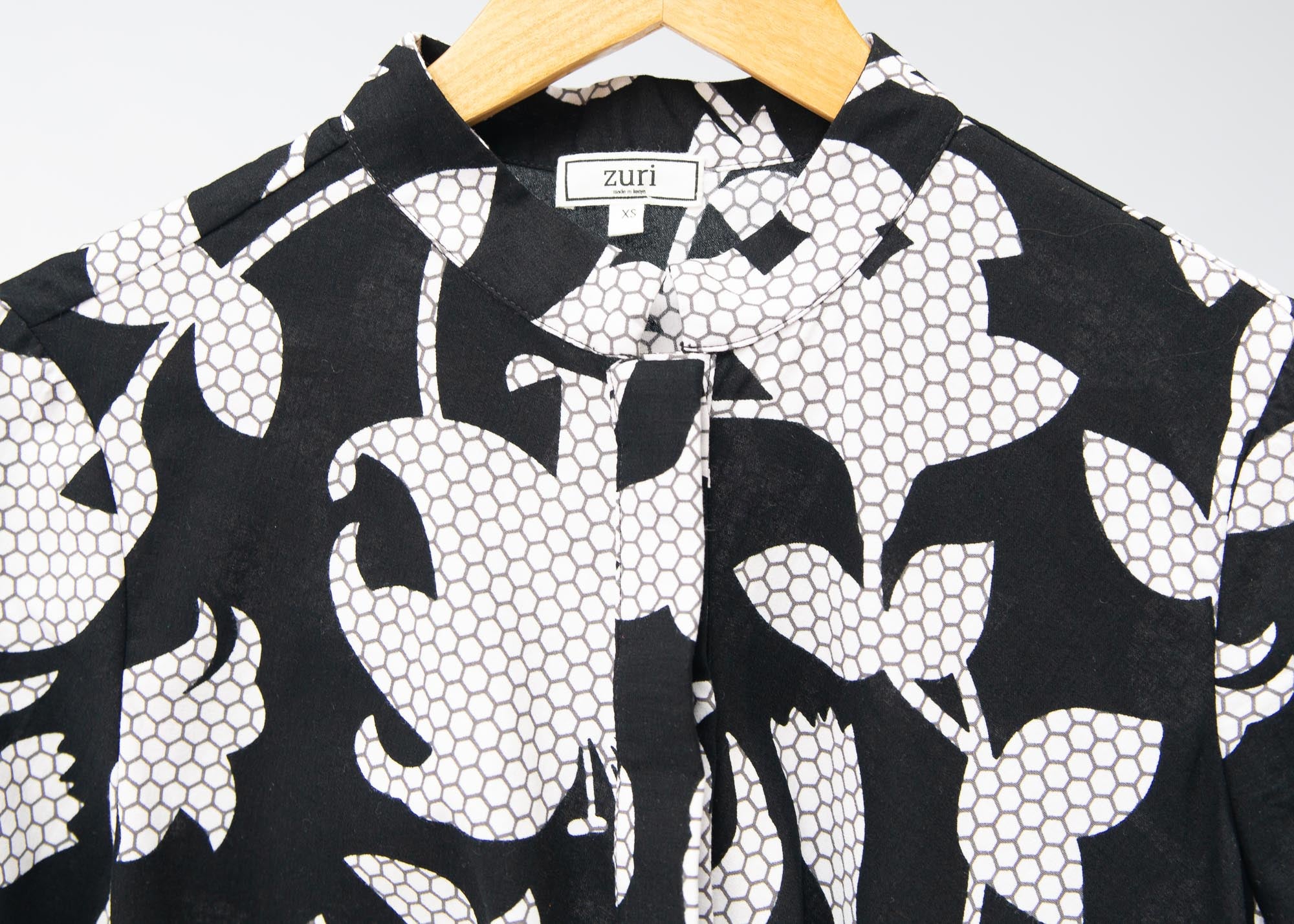 Display of  black dress with white and gray leaf print