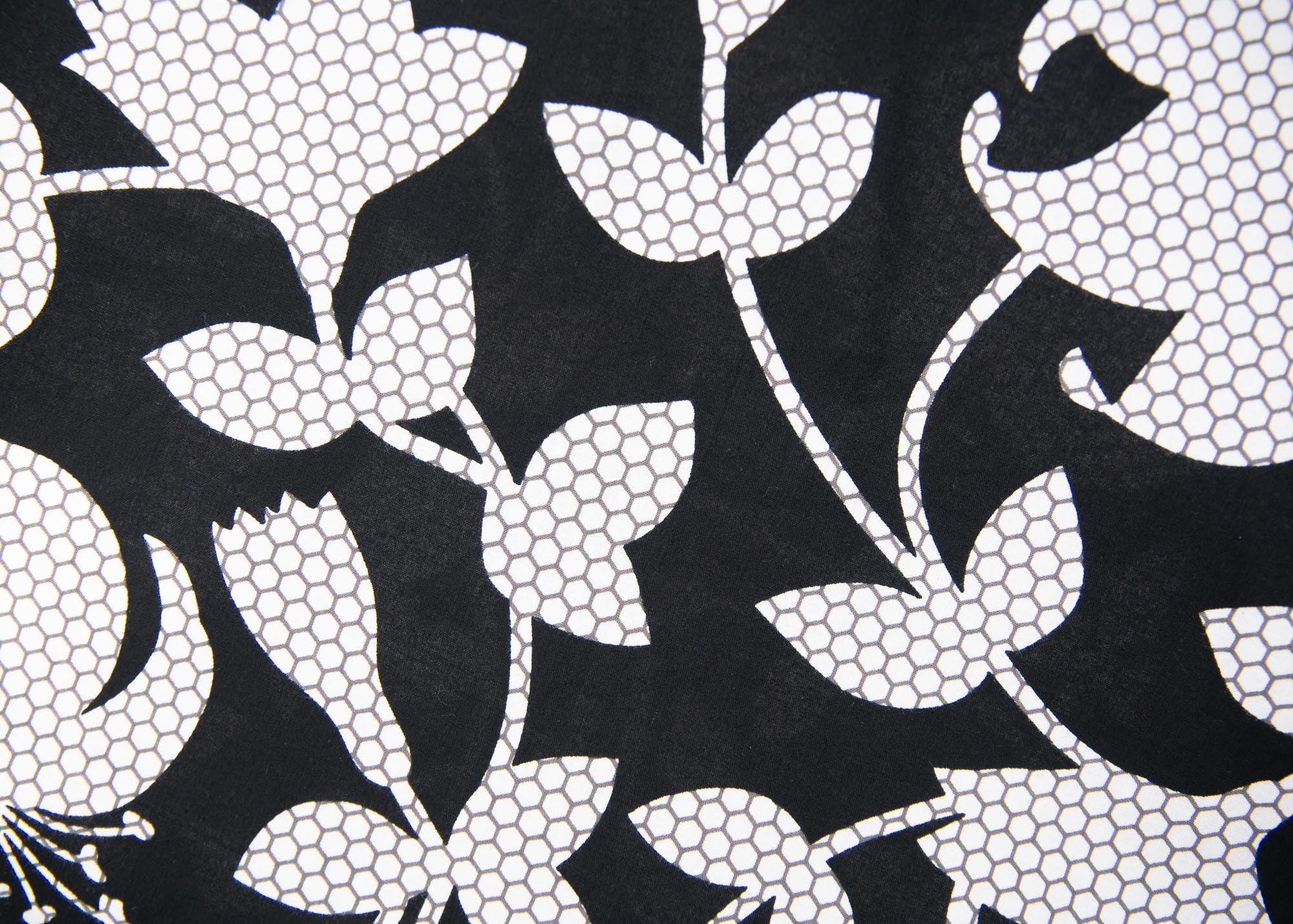 Close up display of  black dress with white and gray leaf print