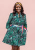 The model is wearing black, green and white geometric print dress