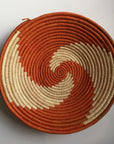 Orange and natural pinwheel design woven bowl