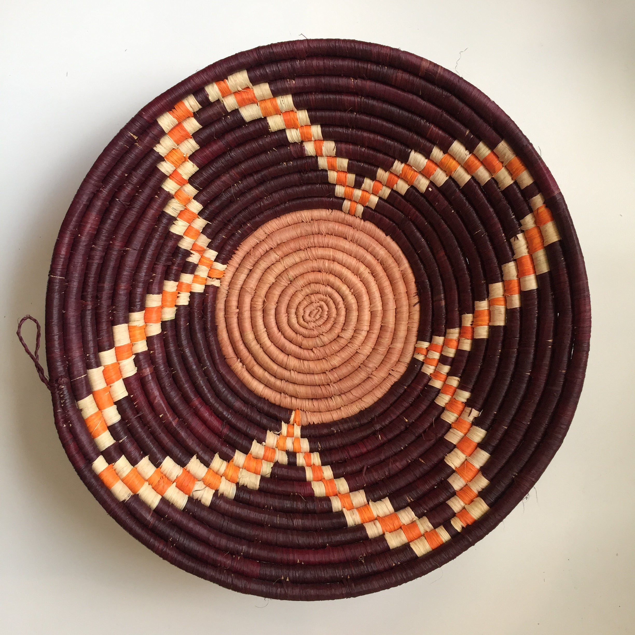 Burgundy and orange flower design woven bowl