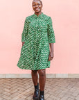 Model wearing green paisley print dress, paired with black boots.