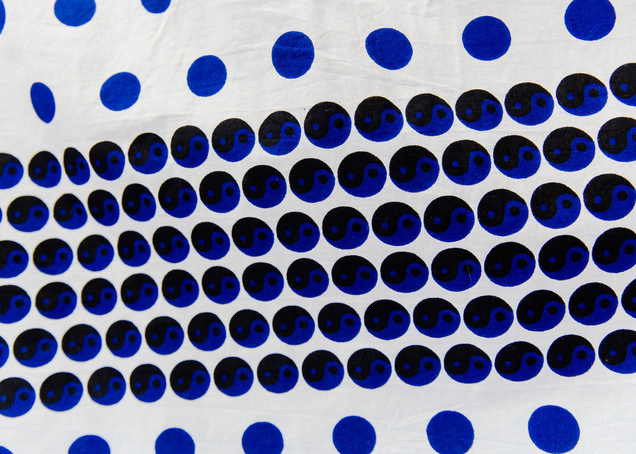 White shirt with blue and black yin yang dots