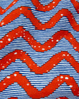 Close up display of blue and red zigzag print fabric.